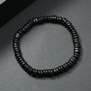 Close-up detail of black wooden abacus beads bracelet, vintage ethnic style jewelry piece.