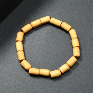 Pulsera de cuentas de madera cilindricas retro, joya unisex simple, detalle de textura natural.