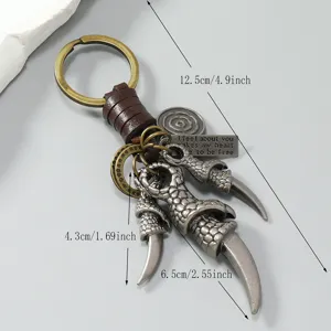 Portachiavi con artiglio di bestia in metallo vintage rétro con corda di cuoio intrecciata.