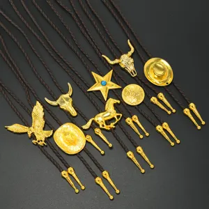 Vintage Western cowboy metal bolo tie necklace with assorted gold pendants brown leather cord