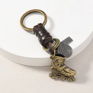 Vintage metal roller skate keychain with leather strap, detailed alloy pendant design.