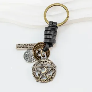 Detailed view of the vintage pentagram leather keychain with moon pendant and metal charms.