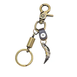Vintage bronze alloy wolf tooth keychain detail, rotating clasp and curved horn pendant.