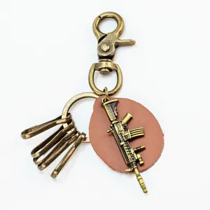 Vintage bronze alloy rifle keychain game prop metal tactical key ring pendant for men.