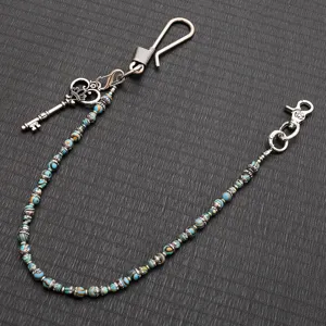 Detailed close-up of retro metal wallet chain with vintage beads and key pendant for punk rock styles.
