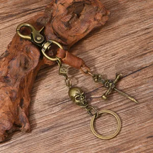 Vintage punk metal skull keychain with hand-woven leather strap and retro sword dice pendant.