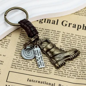 Vintage leather martin boot keychain with alloy pendant, handmade cowhide rope for use.