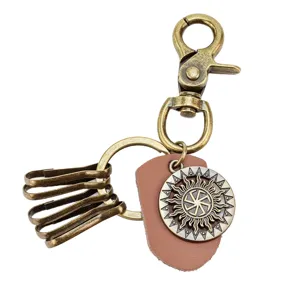 Vintage bronze alloy leather keychain with sun wheel pendant, lobster clasp and key hooks.