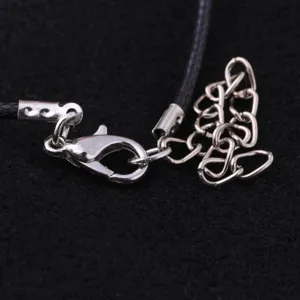 Close-up detail of silver lobster clasp and extension chain for necklace jewelry making.