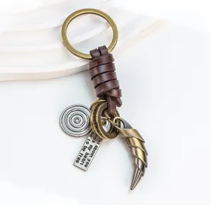 Vintage alloy wolf tooth keychain with leather wrap and curved horn pendant for car keys.