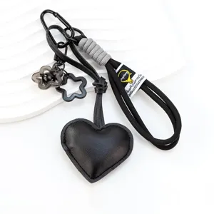 Black leather heart keychain with braided strap carabiner and cute flower charms for bags.