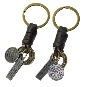 Vintage leather metal keychain with round engraved charms for stylish bag decor.