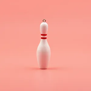 Close-up detail of white mini bowling pin keychain pendant with red stripes and metal ring.