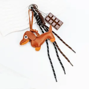 Cute leather dachshund bag charm keychain with chocolate pendant for cute daily accessories.