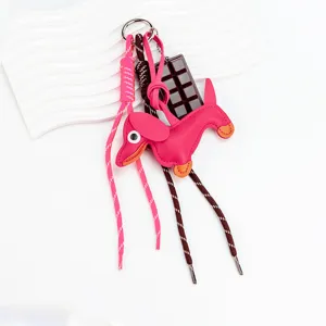 Cute leather dachshund dog keychain bag charm with chocolate pendant and colorful braided ropes.