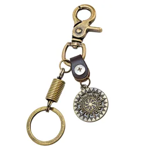 Vintage bronze alloy keychain with genuine leather strap and decorative sun wheel pendant keyring.