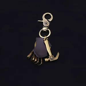 Vintage bronze alloy keychain with leather detail and creative hammer charm pendant.