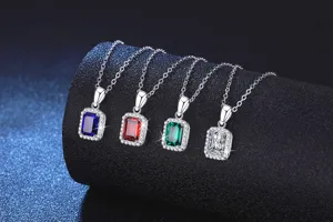 Close-up of four colorful sterling silver square halo gemstone pendant necklaces showing fine details.