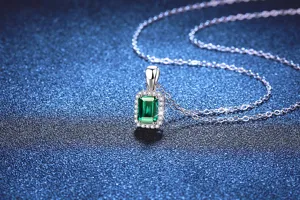Detailed shot of green emerald crystal pendant necklace with sparkling stone close up