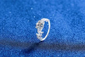 Exquisite moissanite leaf ring detail view, featuring sparkling round stone and silver branch.