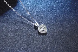 Close-up detail shot of a sparkling silver heart moissanite pendant necklace for women.