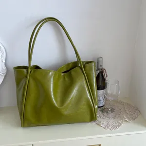 Detailed view of the olive green PU leather tote bag showcasing texture and dual handles.