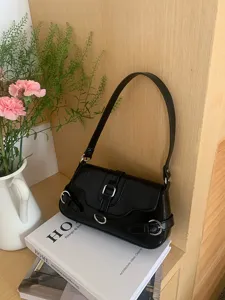 Close-up detail of the black chic motorcycle style shoulder bag with silver hardware.