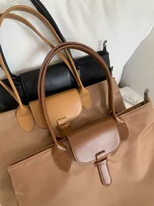 Large capacity nylon tote bag for women, stylish commuting shoulder bag with leather flap details.