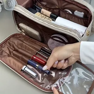 Large capacity cosmetic bag with multiple compartments, brush holders and clear pocket for travel.