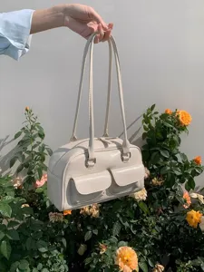 Cream white women shoulder bag with dual straps and front pockets, trendy fashion handbag style.