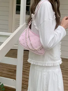 Pink butterfly quilted shoulder bag detail, elegant pearl and metal chain straps design.