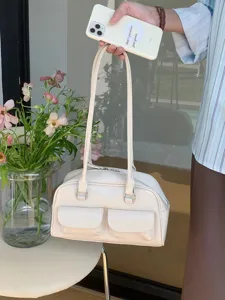 Trendy minimalist cream white shoulder handbag with dual front pockets and top handles for women.