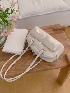 Trendy white shoulder bag with dual pockets, stylish Korean style patent leather handbag for women.