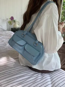 Light blue glossy shoulder bag with dual front pockets and silver ring buckles for daily wear.