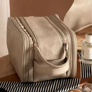 Large capacity multi-zipper cosmetic bag in beige PU leather, portable travel makeup storage pouch.