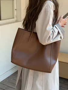 Detailed view of the stylish brown leather tote bag showcasing daily commuting style and large capacity.