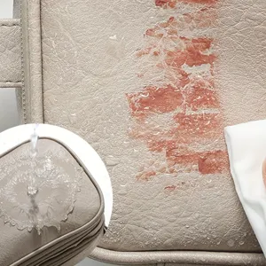 Close-up detail shot of the waterproof leather cosmetic bag showing stain resistance.