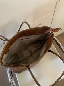 Retro large capacity women shoulder tote bag interior detail view, brown leather casual bag.