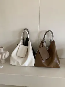 Minimalist leather slouchy hobo tote bag with small pouch detail, casual large capacity.