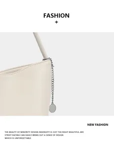 Minimalist beige PU leather shoulder bag detail showcasing elegant silver chain and pendant.