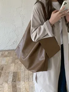 Brown leather tote bag for women, stylish large capacity casual shoulder bag detail view.