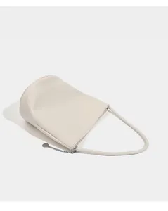 Beige soft leather shoulder bucket bag detail, featuring minimalist design and sleek metal chain.