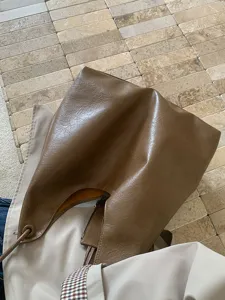 Brown slouchy shoulder bag for women, casual large capacity hobo bag underarm design daily use.