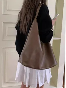 Detail view of the brown leather hobo shoulder bag, showing slouchy design and large capacity.