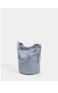 Light blue soft leather bucket bag detail view featuring a delicate metal chain charm.