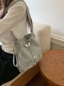 Mint green bucket bag for women, stylish shoulder backpack with cute butterfly pearl pendant.