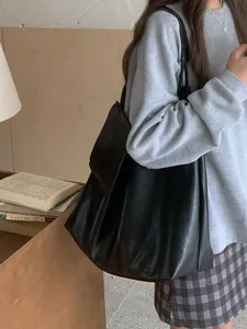 Detailed view of women's black slouchy leather shoulder tote bag, large capacity casual daily bag.