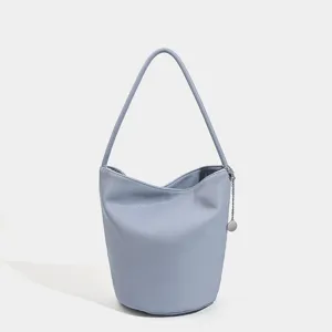 Light blue soft leather bucket bag, chic minimalist shoulder handbag with metal chain accent.