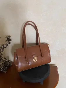 Retro glossy leather shoulder bag for women, chic vintage briefcase tote for daily commute.