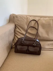 Detailed view of the dark brown patent leather shoulder bag, trendy daily handbag.